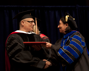 Bittner receives the honorary degree from Newman President Noreen M. Carrocci, Ph.D.