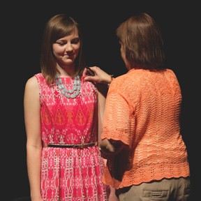 Angela Entz of Whitewater, Kan., receives the Newman University Occupational Therapy Assistant pin from her mother during the OTA pinning ceremony May 10. Entz also received the Outstanding OTA Student Award for 2014.