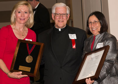 Newman Board of Trustees Chair Linda Davison and President Noreen M. Carrocci, Ph.D. present the Cardinal Newman Medal and Proclamation to Monsignor Robert Hemberger. 
