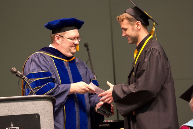 Alex Beck accepts the Harvey J. Ablah Award from Provost Michael Austin, Ph.D.