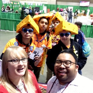 Admission Counselors Georgia Drews and Peter Abella take a selfie with cheese heads.