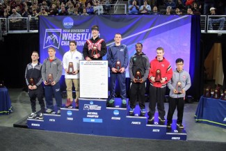 Dustin Reed receives his All-American trophy with the other 125 pound top finishers at teh NCAA DII Championships.