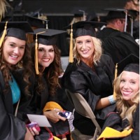 Newman University graduate students visit prior to the start of commencement.