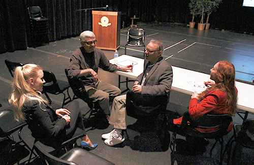 Theatre major Josephina Gregory-Jenkins discusses her project with, from left, project sponsors Ray Wills, associate professor of theatre, and Mark Mannette, director of theatre, and assessor Susan Crane-Laracuente, associate professor of English.