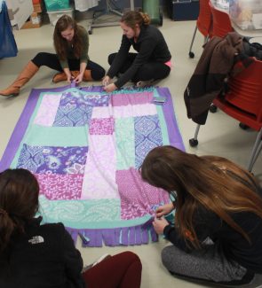 Students making a blanket