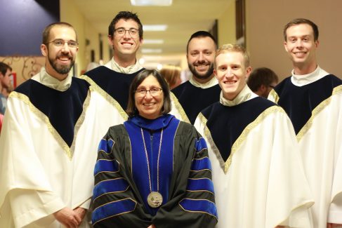 Past president Noreen M. Carrocci, Ph.D. (center) stand with (l to r) the Rev. J.D. Betzen, the Rev. Andrew Labenz, the Rev. Herzog, the Rev. Adam Grellinger (former campus chaplain) and the Rev. Kyle Dugan.