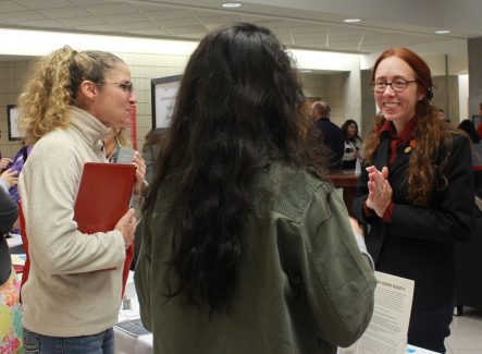 Associate Professor of English Susan Crane-Laracuente (right) talks with visitors during Preview Day.