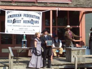 Mr. and Mrs. Edens receive an award for their reenactment at Cowtown.
