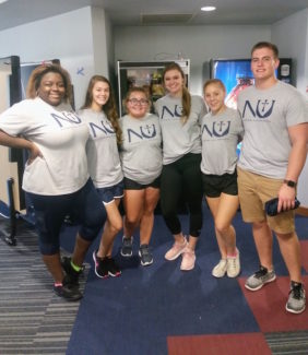 Members of the Newman Cheer and Dance team, including freshmen Dominica Johnson (far left) and Peyton Keller (fourth from the left) brought their spirit and enthusiasm to students and parents on move-in day.