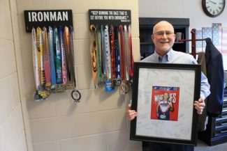 Andrews displays his finishing medals from past races in his McNeil Hall office.