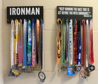 Just above Andrews' medals, he displays a quote: "'Keep running the race that is set before you with endurance,' Hebrews 12:1." 