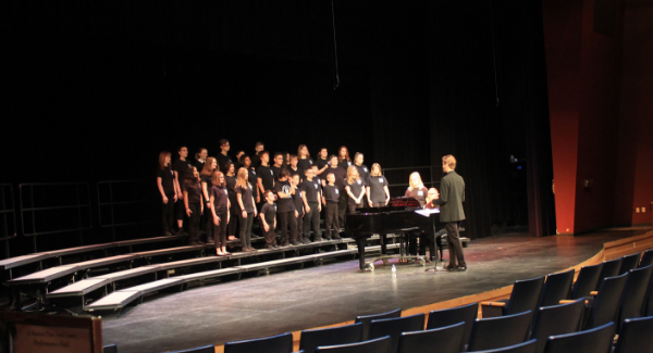 Middle School choir group performs on stage.