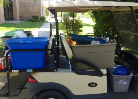 Security golf cart is loaded full with donations. 