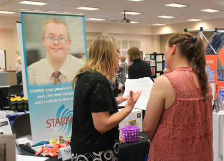 Student talks to exhibitor at the Highway 54 career fair.