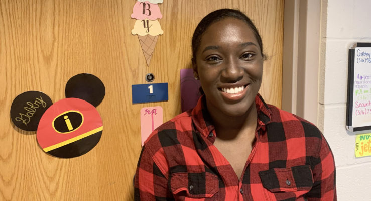 Altenor as a student outside her residence hall room at Newman University.