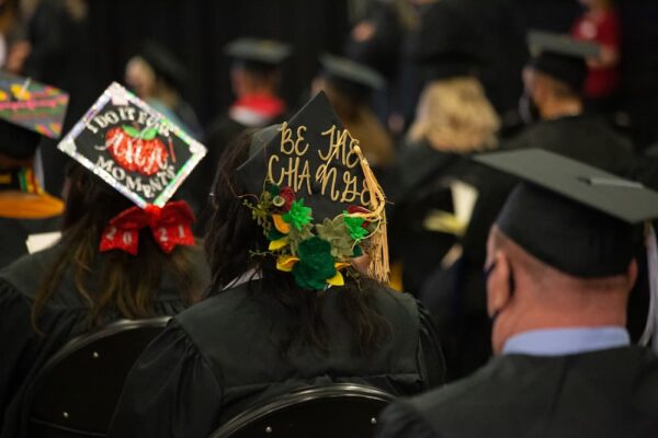 "Be the Change" creatively displayed on a graduate's cap.