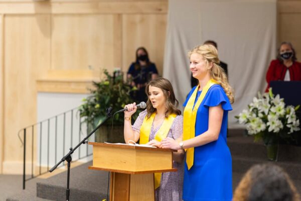 Graduates Kirsten Adolph and Clare Morgan led the student address, which included a lighthearted segment, "How You Know You're a Newman Nursing Student."