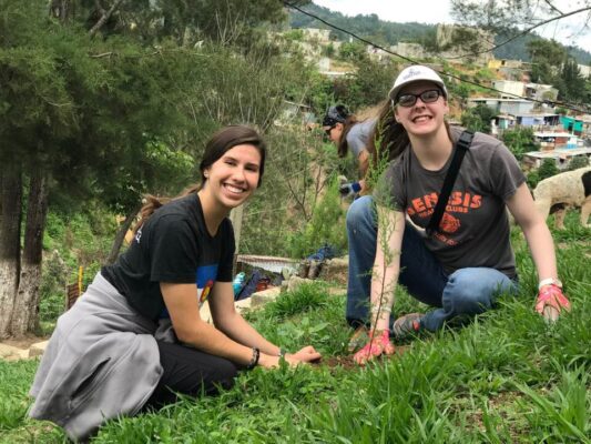 Marie O'Neal aids a fellow student in reforestation with the Sangre de Cristo Health Care Project in Santa María de Los Altos, Guatemala