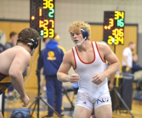 Dalton Weidl prepares to wrestle a fellow competitor at a Newman match.
