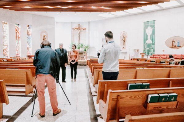 Matt Riedl, far left, shoots video for the Catholic Diocese of Arlington.