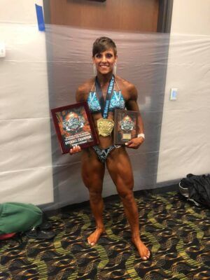 Sgt. Katasha Bledsoe shows off her first place medal at a bodybuilder competition.