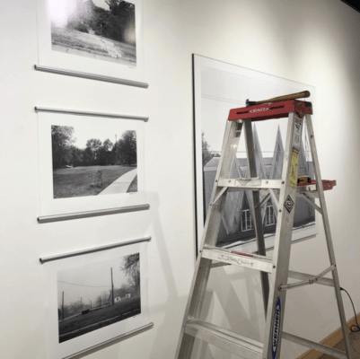 A ladder stands near photographs in the Steckline Gallery.