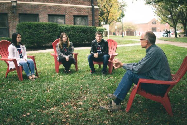 (Far left) Kelly McFall leads an outdoor class with students in the Honors Program.
