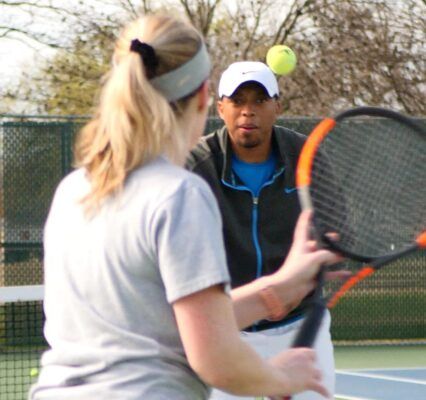 Regis Fox coaches one of his Royalty Tennis players.