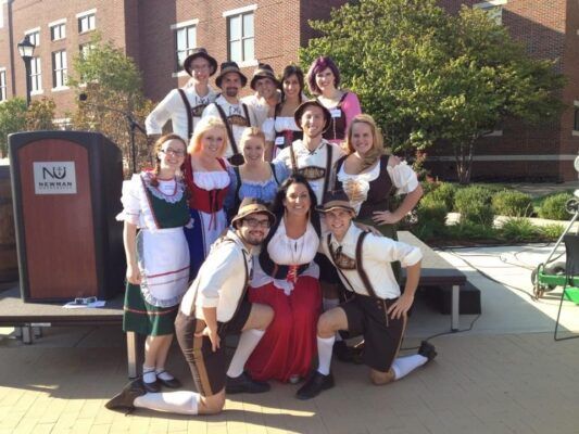 The Newman Troubadours sport their Oktoberfest attire at the 2015 Party on the Plaza.