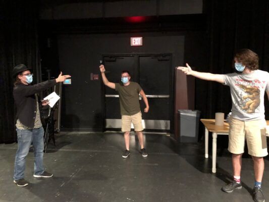 Three cast members rehearse for "Murder at Cafe Noir." Photo courtesy of The Vantage.