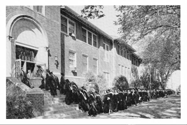 Graduates enter Sacred Heart Hall for their long-awaited commencement ceremony. Photo courtesy of Newman University Archives. 