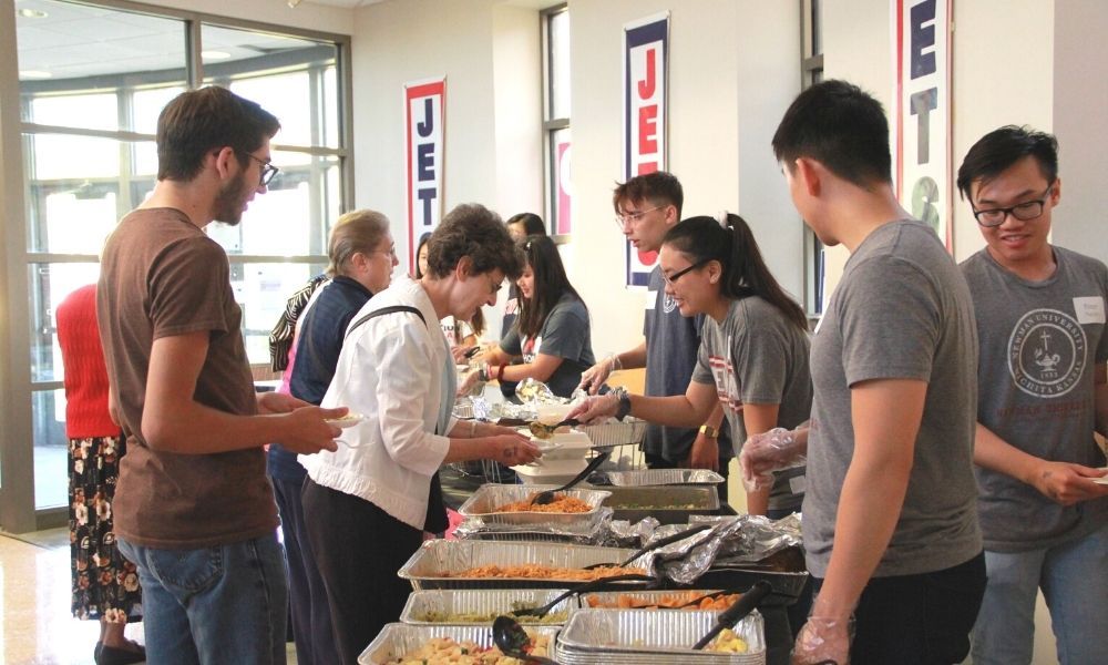 Students serve guests a buffet-style assortment of delicious, culturally diverse foods.
