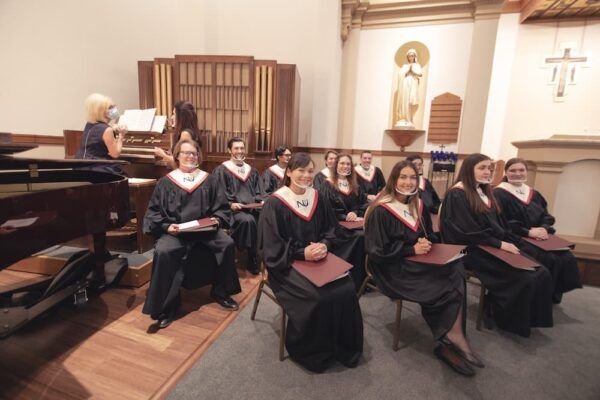 The Newman Chorale and Troubadours, led by Director of Music Deanne Zogleman, sang hymns throughout the Mass of the Holy Spirit.