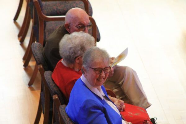 Sister Susan Welsby sits with her mother and father — both of whom are in their 90s — for the celebratory Mass.