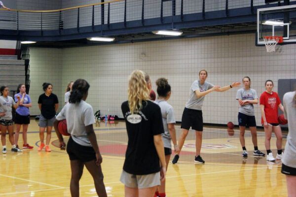 Coach Nicole instructs attendees of an elite basketball camp held at Newman over the summer. 