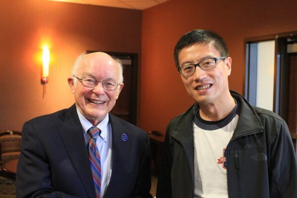 Larry Heck with colleague Huachuan Wen, associate professor of education at Newman.