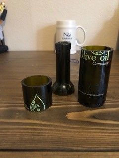 An olive oil bottle cut into three pieces