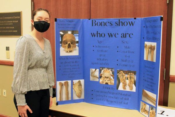 Senior Mattie Schindler presents "Bones show who we are," an anthropologic study, during Scholars Day.