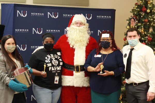(Front center) Advisor for special populations Scott Mudloff dresses as Santa and poses with those voted "best dressed" for "The Office" theme.