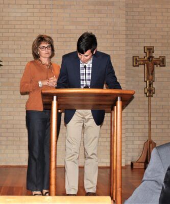 Christine Ostroski stands with her son during a Mass for the Holy Family Foundation