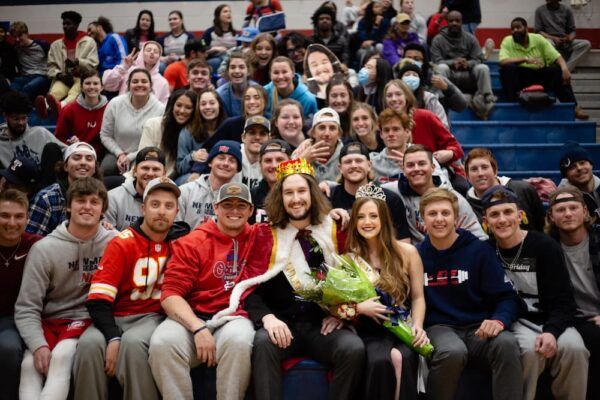 King Daniel Knolla and Queen Marie Moore surrounded by a crowd of Newman Jets!