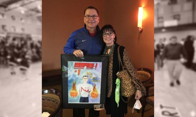 Mark and Nanette Potter hold a painting gifted by student Joshua Prilliman.