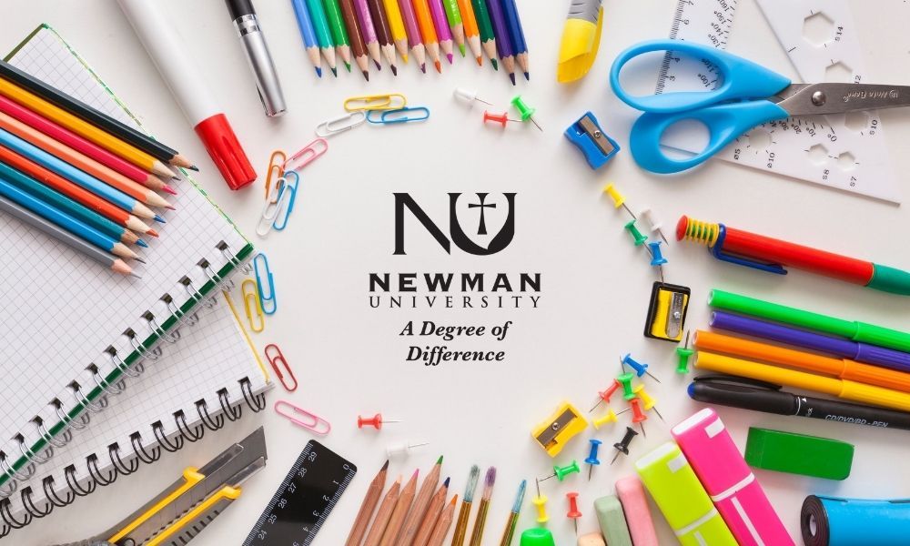 Desk with pens, pencils, paperclips, all surrounding the Newman University logo that states "A Degree of Difference."
