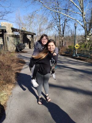 Iveth De Loera strolls through the St. Louis Zoo with Ariel Johnson  on her back. 