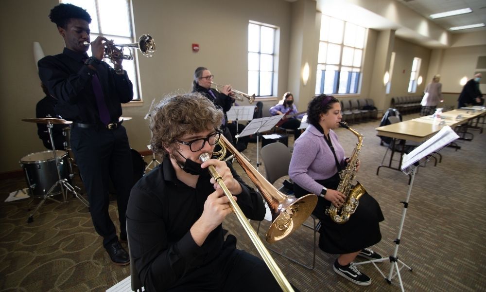 Jazzy Jets band plays for attendees of a Newman Board of Trustees meeting.