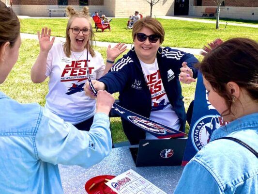 Georgia Drewes (left) sports her Jet Fest shirt while welcoming accepted students to campus.