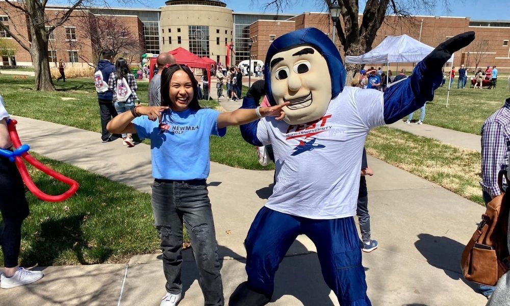 Newman University Mascot Johnny Jet strikes a pose with a first-year student.