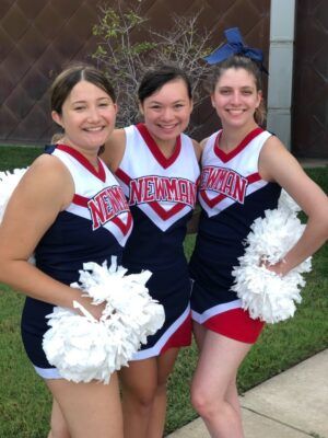Emily Smith (far right) likens her experience on the Newman Cheer and Dance team to that of a family.