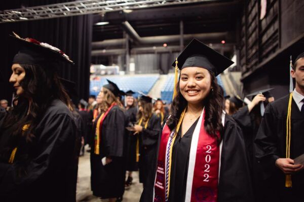2022 Newman graduate Kelly Mai smiles proudly on commencement day May 6.