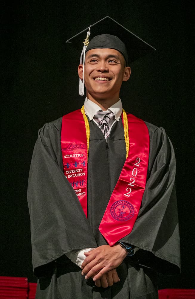 Steven Nguyen smiles to his family from the Newman commencement stage ...